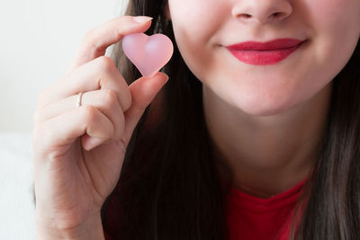 Close-up portrait of woman holding candy