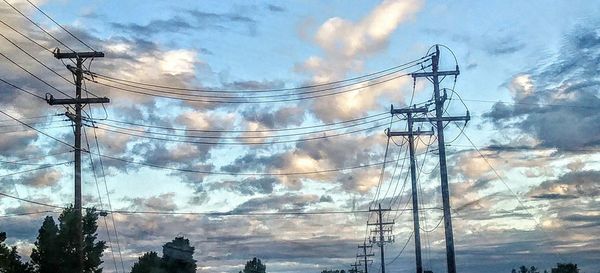 Low angle view of electricity pylon against sky