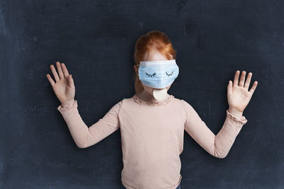 Portrait of boy standing against wall