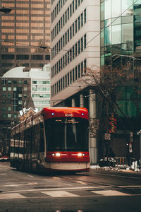 Cars on street by buildings in city