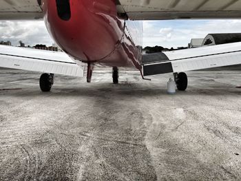 Cropped image of airplane on airport runway