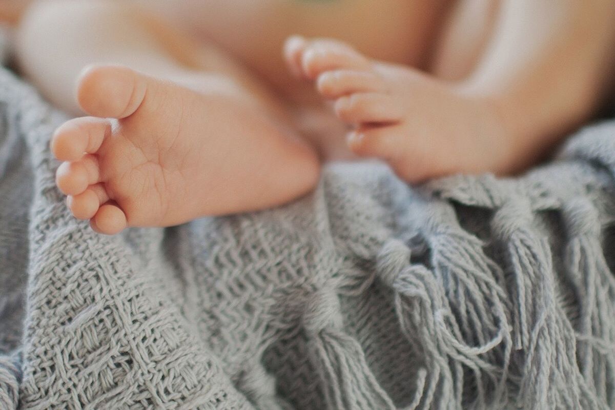 CLOSE-UP OF WOMAN WITH BABY FEET