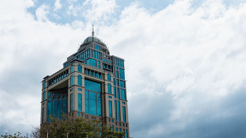 Low angle view of building against cloudy sky