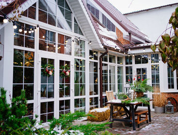 Chairs and tables against building in city