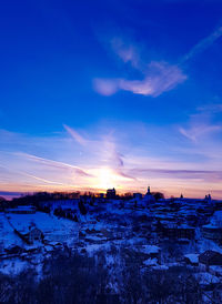 Scenic view of city during winter against sky