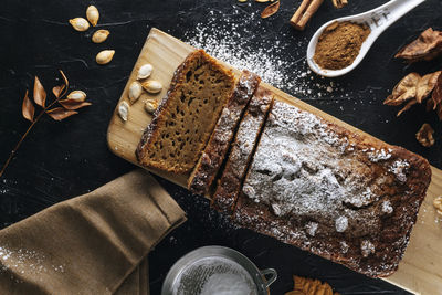 Pumpkin sponge cake cut into slices with powdered sugar on top