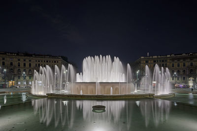 View of fountain in city at night