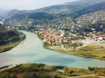 High angle view of river amidst cityscape against sky