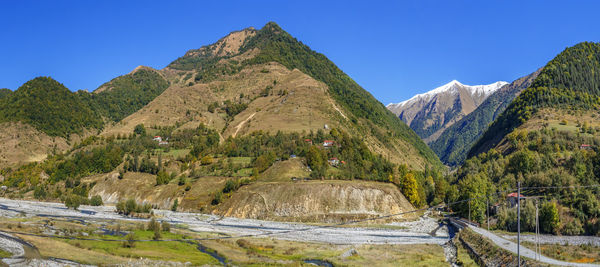 Scenic view of mountains against clear blue sky