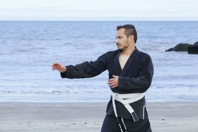 Full length of man standing on beach