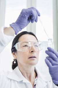 Mature scientist analyzing chemical in laboratory