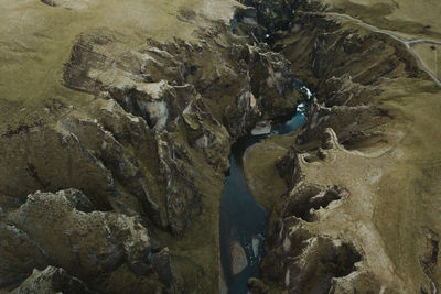 High angle view of stream flowing through rocks