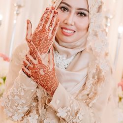 Close-up portrait of bride showing henna tattoo