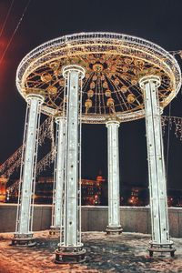 Low angle view of rollercoaster against sky at night