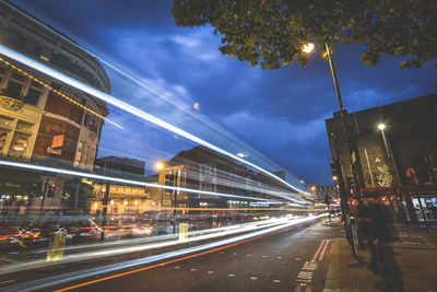 Light trails on road against sky at night