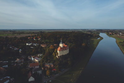 High angle view of city buildings against cloudy sky