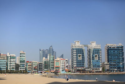 Modern cityscape against clear blue sky