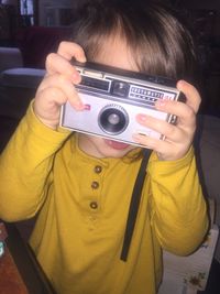 Midsection of girl photographing