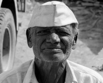 Close-up portrait of senior man wearing cap