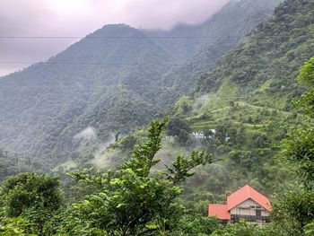 Scenic view of mountains and buildings against sky