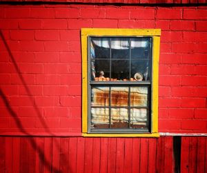 Close-up of window on red brick wall