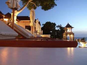 Illuminated building against sky at dusk