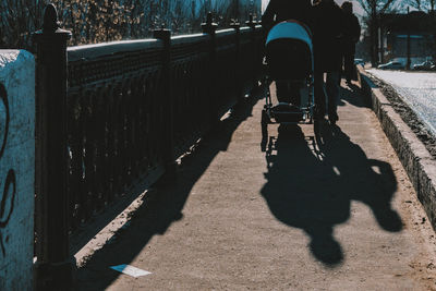 Rear view of man riding bicycle on road