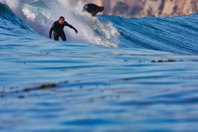 Full length of man surfing in sea