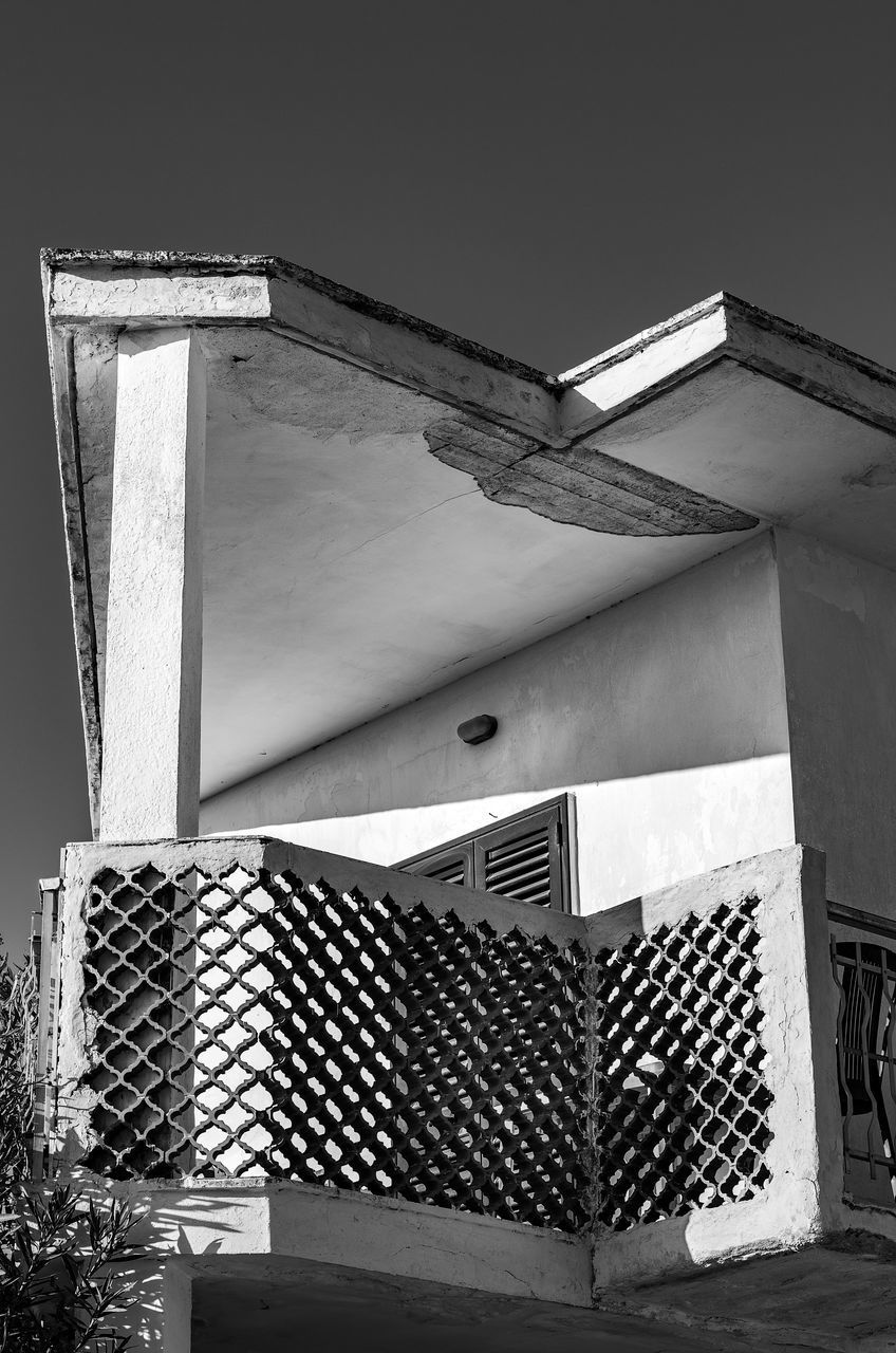 LOW ANGLE VIEW OF HOUSE AGAINST BUILDING