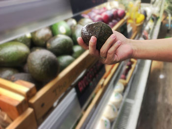 Person holding food at market stall