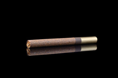 Close-up of cigarette against black background