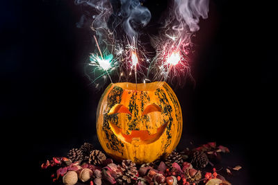 Close-up of illuminated pumpkin against black background