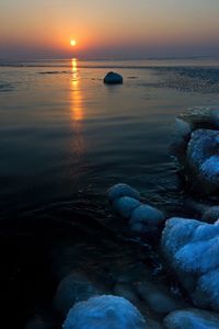 Scenic view of sea at sunset