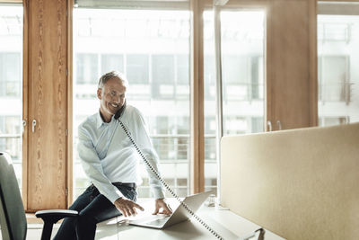 Man sitting on table at home