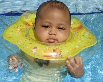 Portrait of cute baby girl in swimming pool