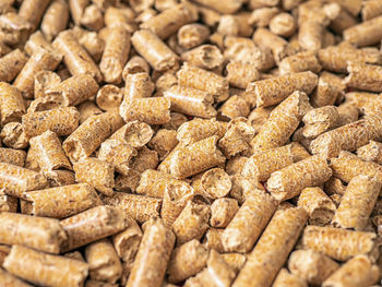 Natural wooden pellets background as renewable energy. close-up wood pellet pattern. top view