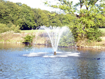 Water splashing in fountain against sky