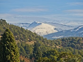 Scenic view of landscape and mountains against sky