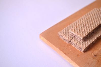 Close-up of cake on table against white background