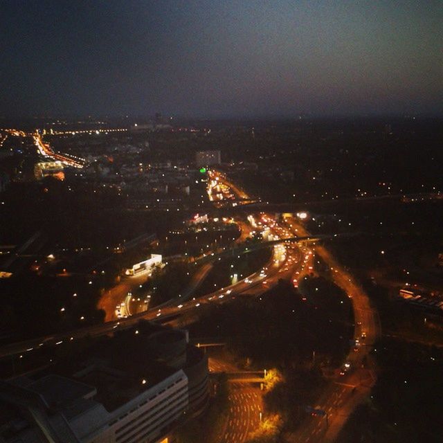 night, illuminated, city, cityscape, high angle view, aerial view, architecture, built structure, building exterior, city life, crowded, sky, road, transportation, landscape, dark, outdoors, copy space, no people, light trail