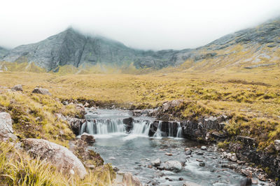 Scenic view of waterfall against sky