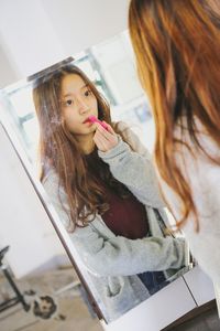 Portrait of young woman lying on floor