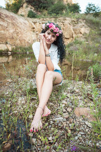 Portrait of a smiling young woman sitting outdoors