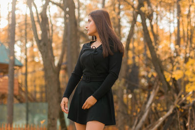 Young woman standing in forest