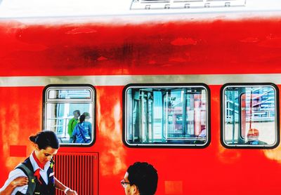 Rear view of people on train window