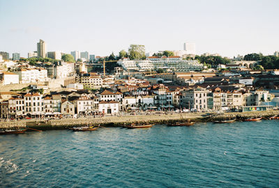 Townscape by sea against clear sky