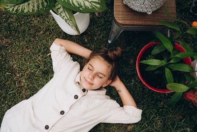 High angle view of girl laying on grassy field