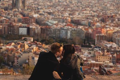 Young man and townscape against buildings in city