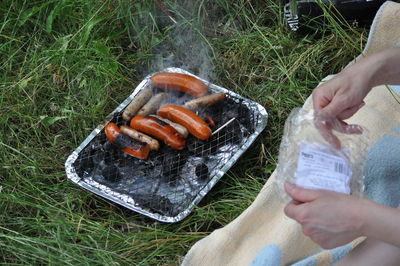 High angle view of man preparing food on barbecue grill