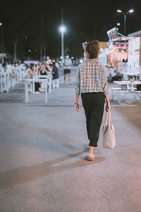 Series photo of young woman tourist wear surgical medical mask touring in street night market